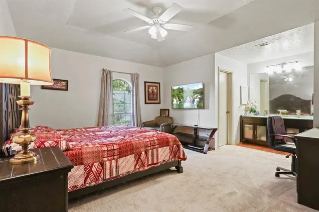 a bedroom with a bed couch and window