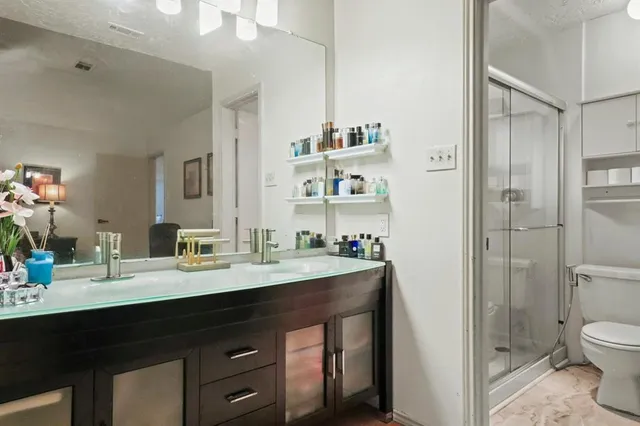 a bathroom with a toilet and a shower