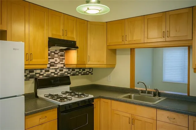a kitchen with stainless steel appliances granite countertop a stove and a sink