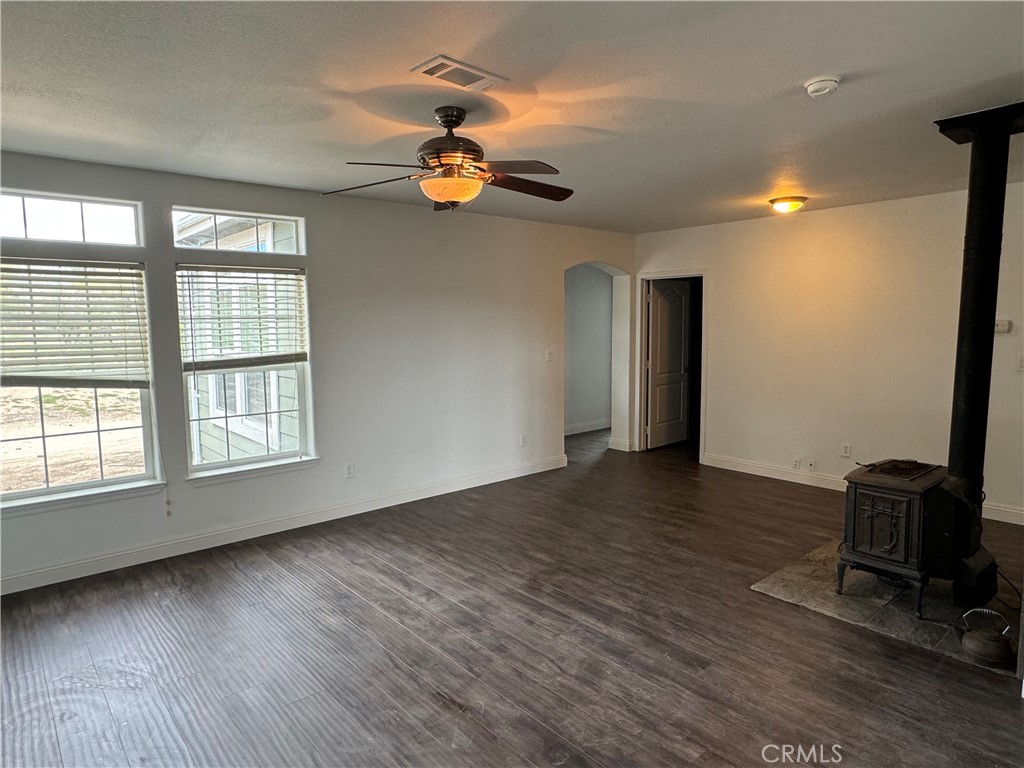57725 Ramsey Road Anza, CA 92539 - Photo 14 of 43 an empty room with wooden floor and windows