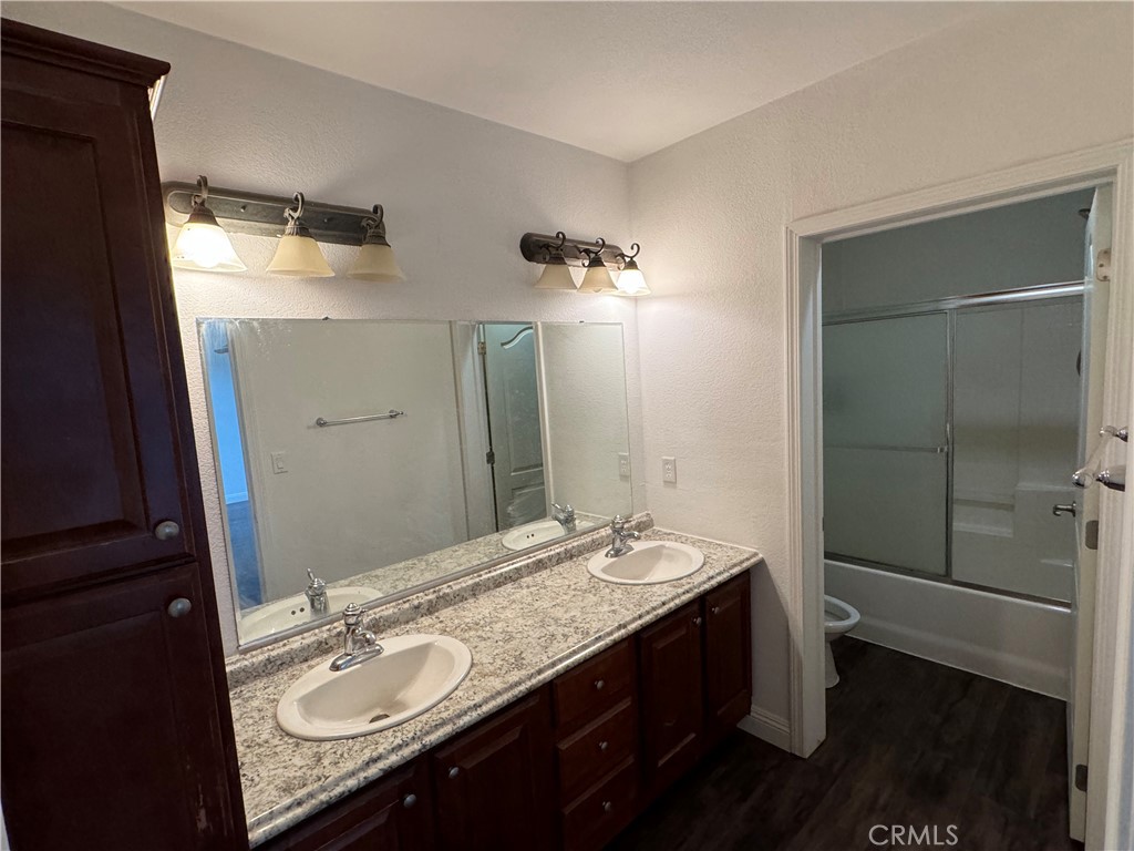 57725 Ramsey Road Anza, CA 92539 - Photo 17 of 43 a bathroom with a granite countertop sink two mirror and shower