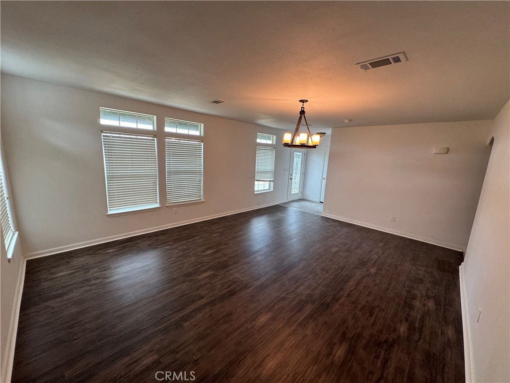 57725 Ramsey Road Anza, CA 92539 - Photo 2 of 43 an empty room with wooden floor chandelier and windows