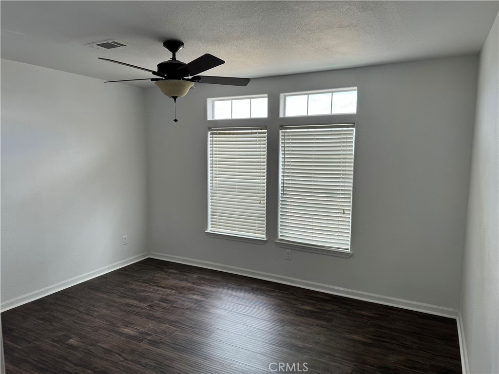 57725 Ramsey Road Anza, CA 92539 - Photo 21 of 43 a view of an empty room with wooden floor and a window