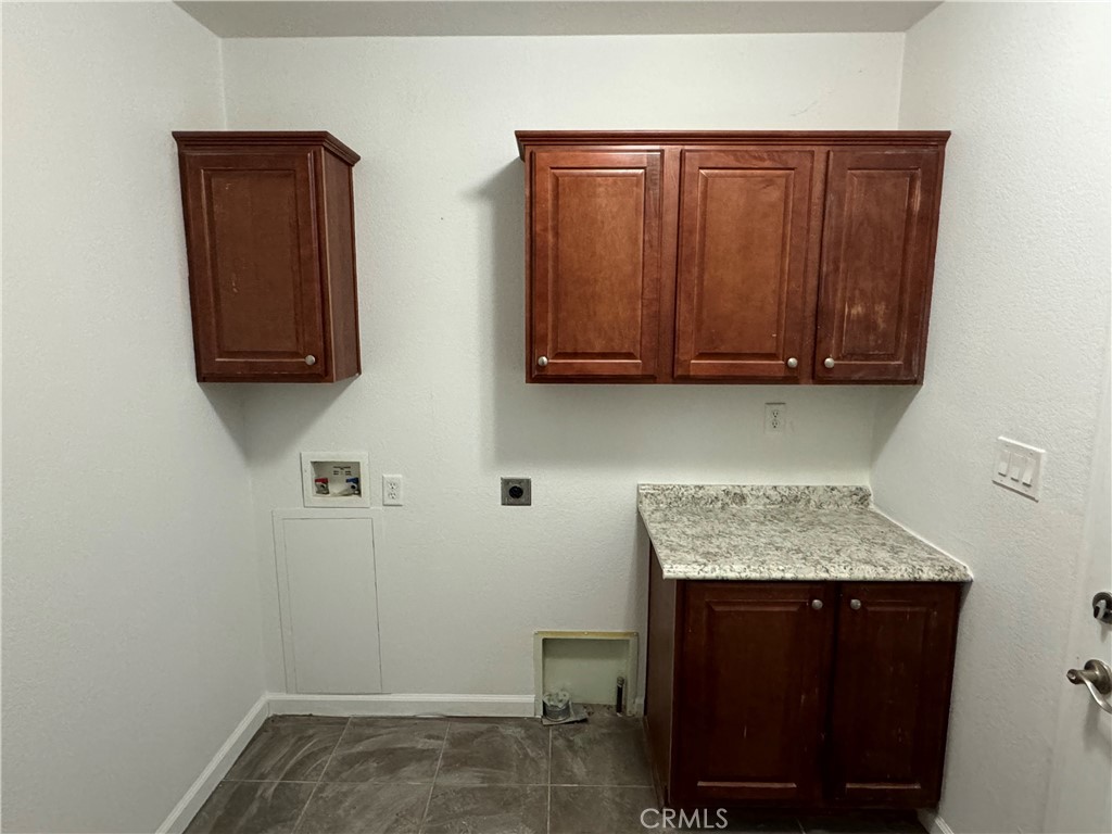 57725 Ramsey Road Anza, CA 92539 - Photo 31 of 43 a storage room with wooden cabinets