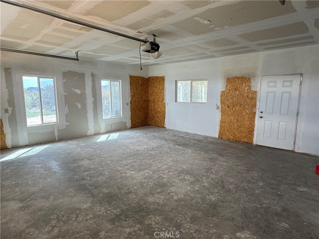 57725 Ramsey Road Anza, CA 92539 - Photo 33 of 43 an empty room with windows and cabinet