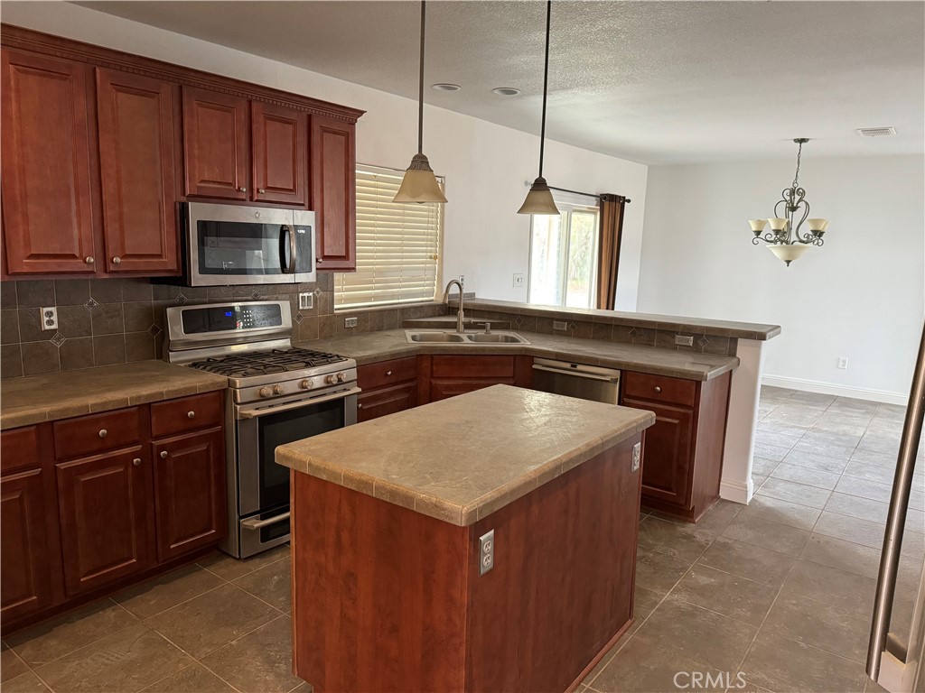 57725 Ramsey Road Anza, CA 92539 - Photo 8 of 43 a kitchen with a sink stove and microwave