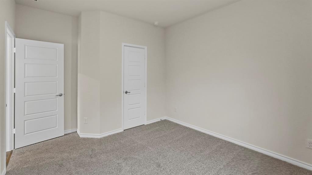 447 Epiphany Lane Lavon, TX 75166 - Photo 23 of 31 Light gray textured carpeting with white baseboards