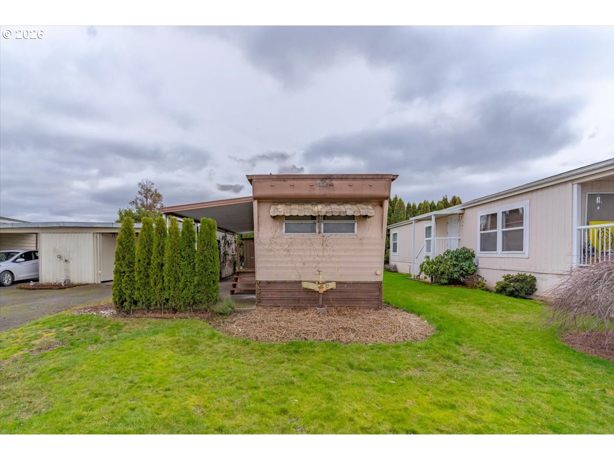 5422 Portland Road Northeast, Unit 10 Salem, OR 97305 - Photo 1 of 25 a view of a house with a back yard