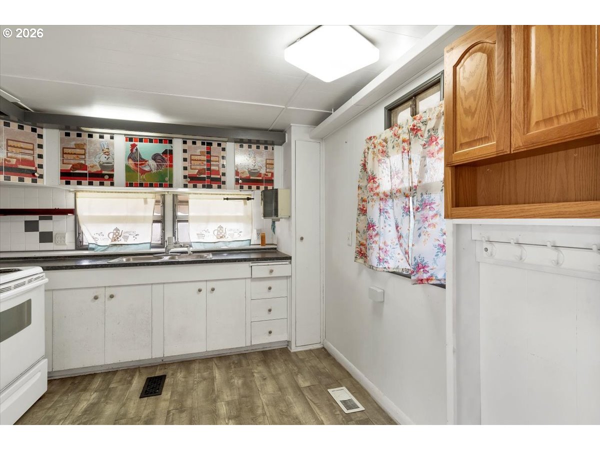 5422 Portland Road Northeast, Unit 10 Salem, OR 97305 - Photo 15 of 25 a kitchen with granite countertop white cabinets and stainless steel appliances