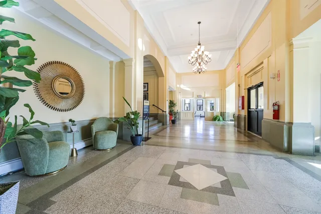 a lobby with furniture and a chandelier