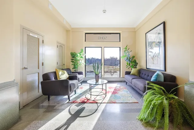 a living room with furniture and a large window