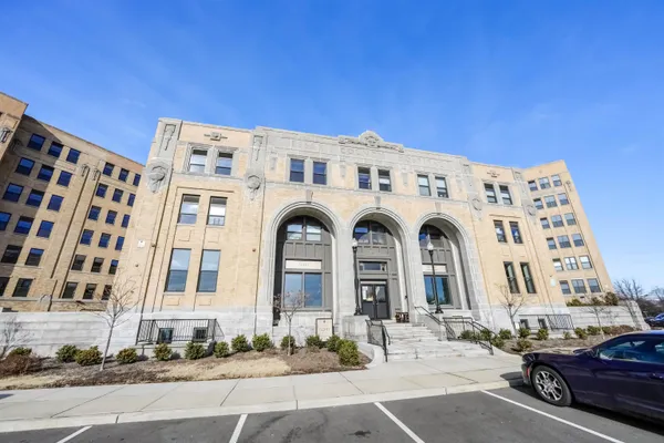 a view of a building with parking space