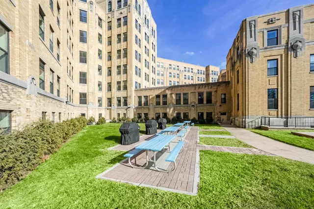 a view of a workspace with furniture a rug and a window