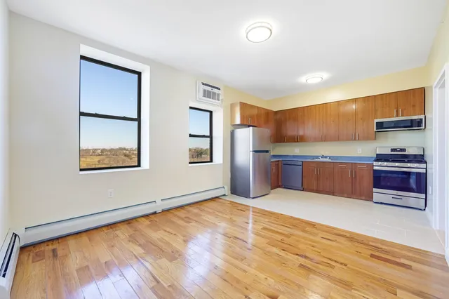 a kitchen with stainless steel appliances granite countertop a refrigerator and a stove top oven