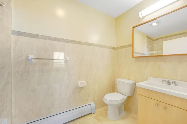 a bathroom with a toilet sink and a shower