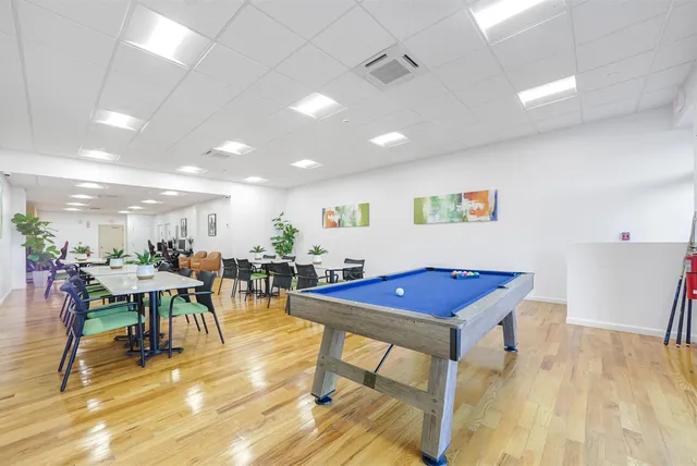 a view of a room with furniture and wooden floor