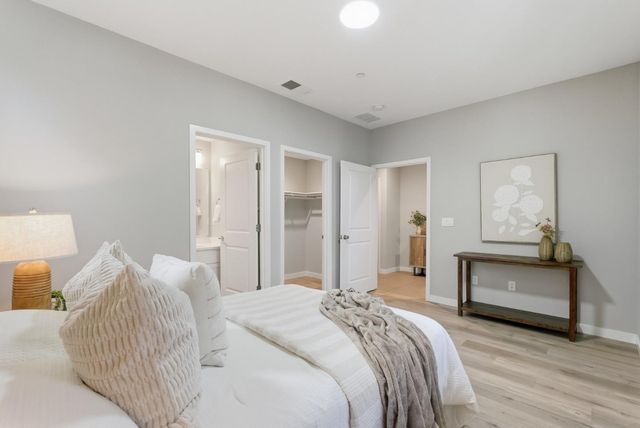 a bedroom with a bed and a chandelier