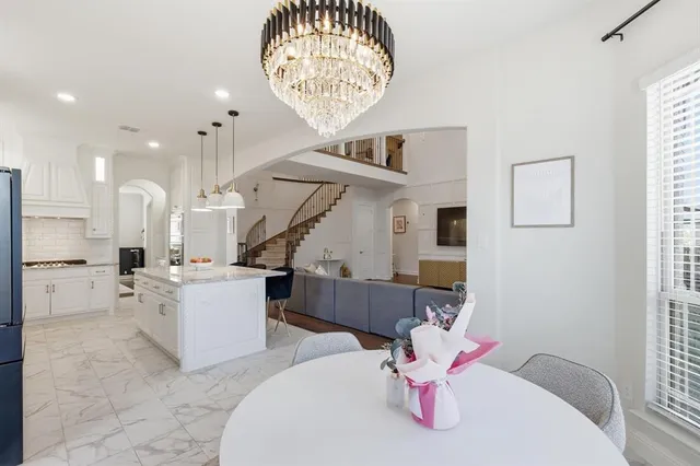 a living room with furniture and kitchen view