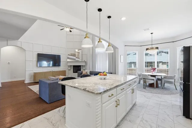 a open kitchen with a sink a stove and chairs
