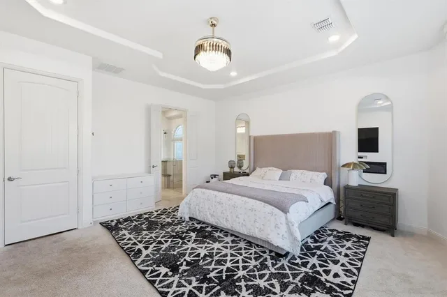 a bedroom with a bed and a chandelier