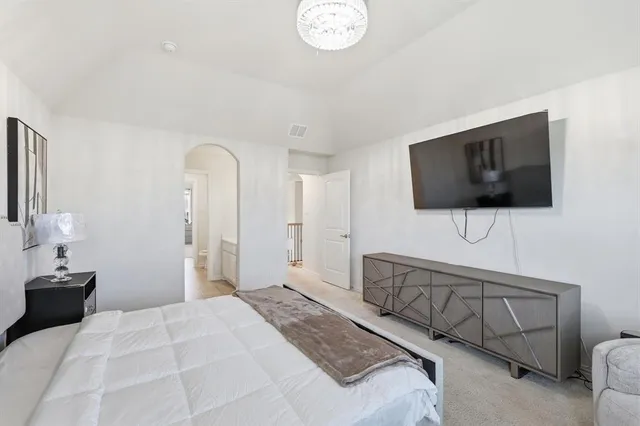 a spacious bedroom with a bed and a couch