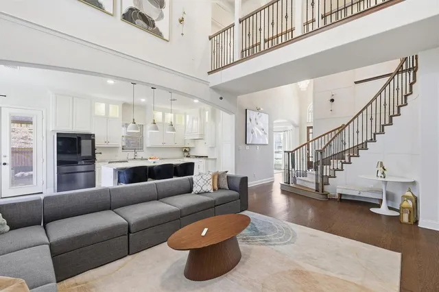 a living room with furniture and a dining table