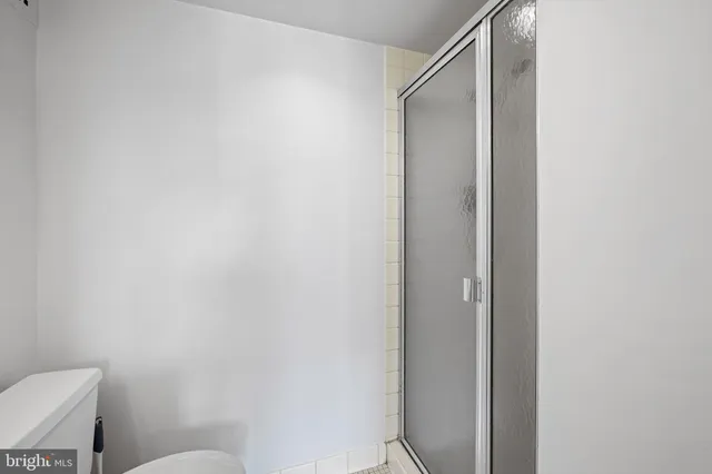 a bathroom with a toilet and a shower
