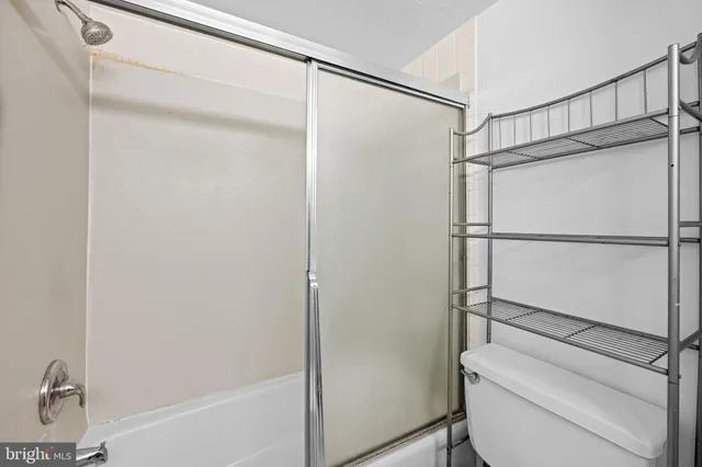 a bathroom with a glass shower door