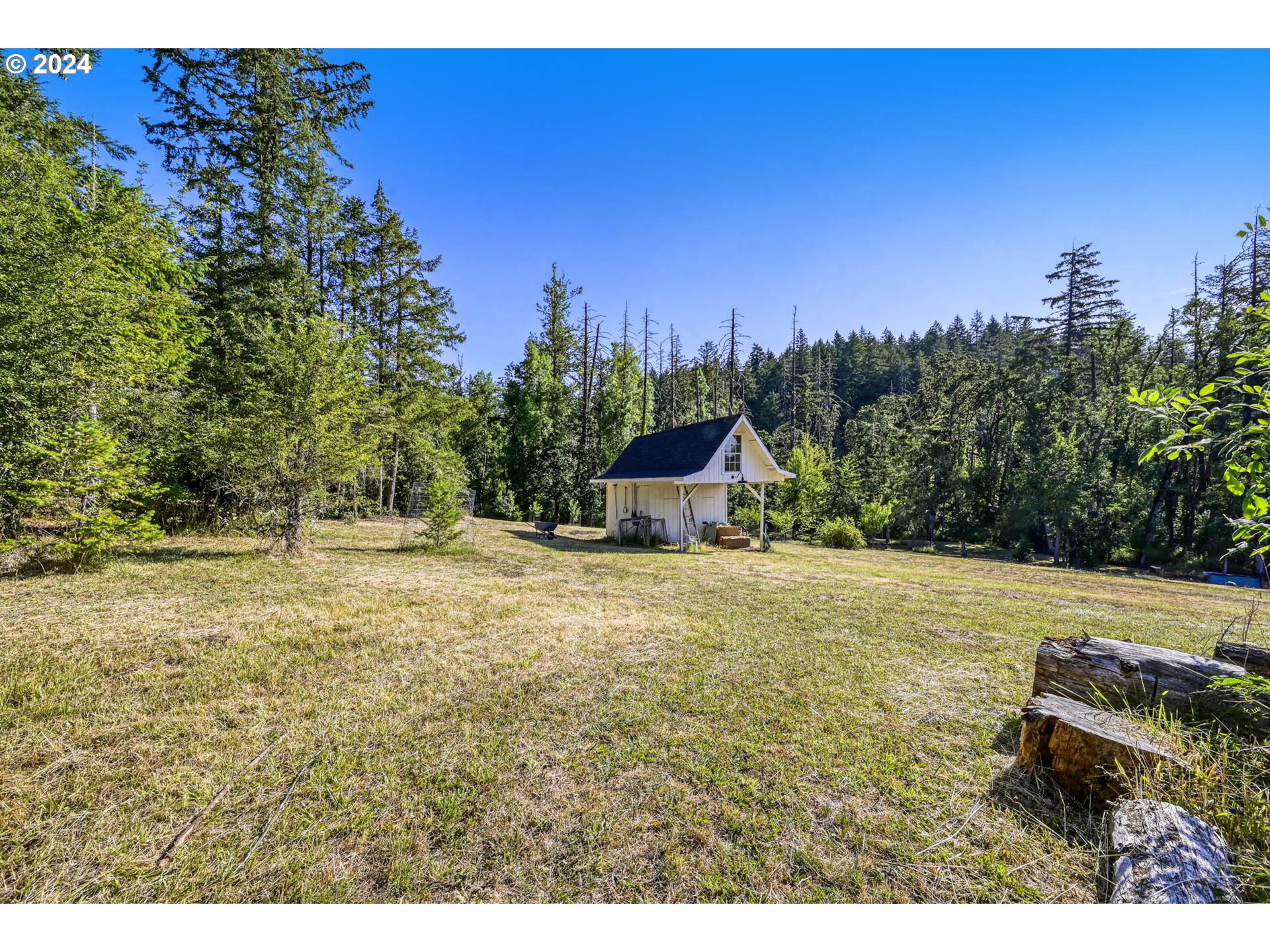 Ridgetop Drive, Unit 15 Eugene, OR 97405 - Photo 1 of 19 a backyard of a house with table and chairs