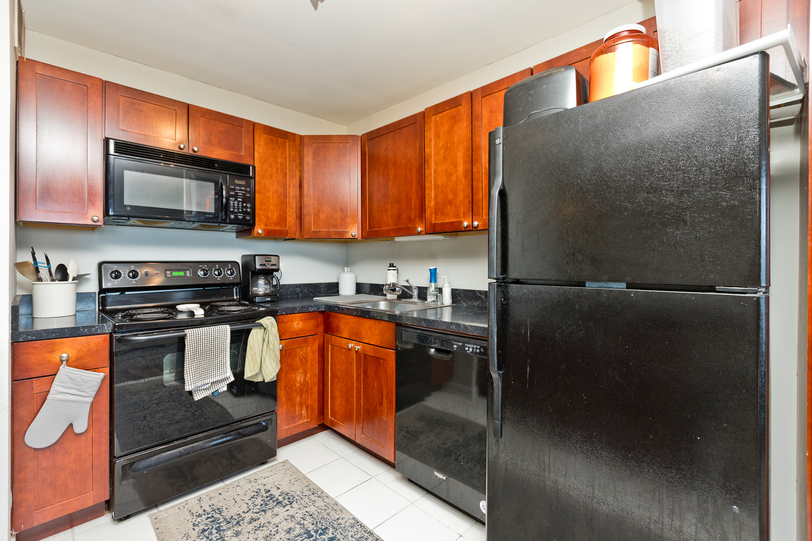 655 West Irving Park Road, Unit 4008 Chicago, IL 60613 - Photo 11 of 16 a kitchen with stainless steel appliances granite countertop a refrigerator and a sink