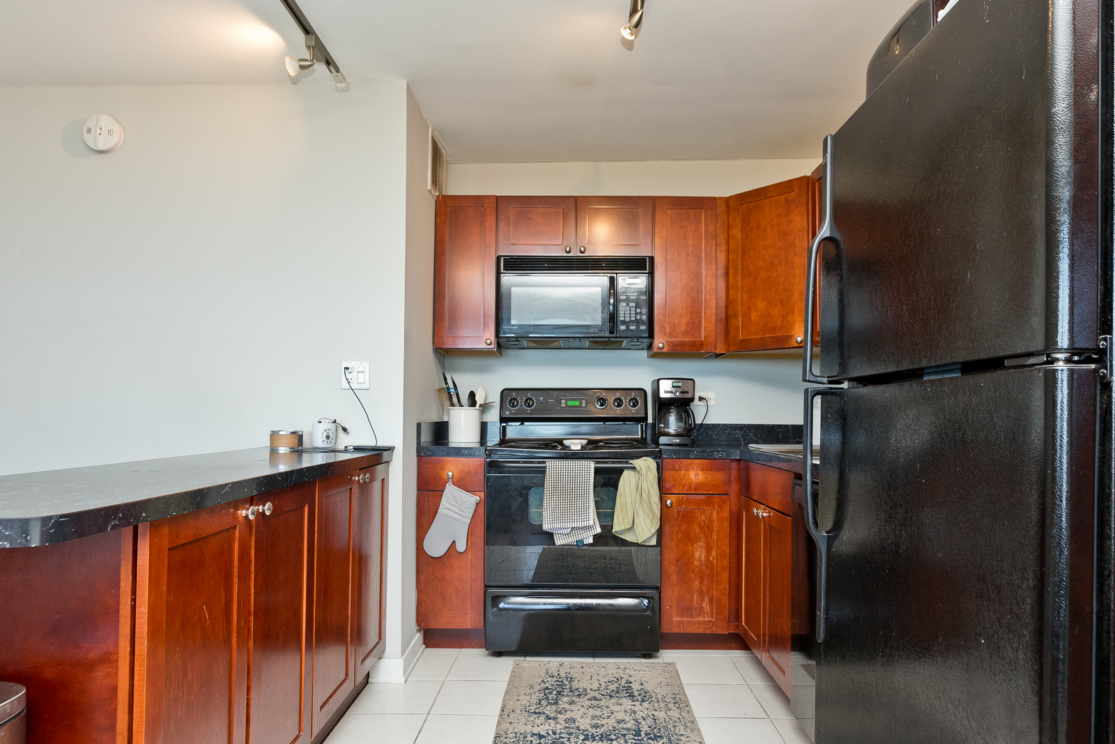 655 West Irving Park Road, Unit 4008 Chicago, IL 60613 - Photo 12 of 16 a kitchen with stainless steel appliances granite countertop a refrigerator and a stove
