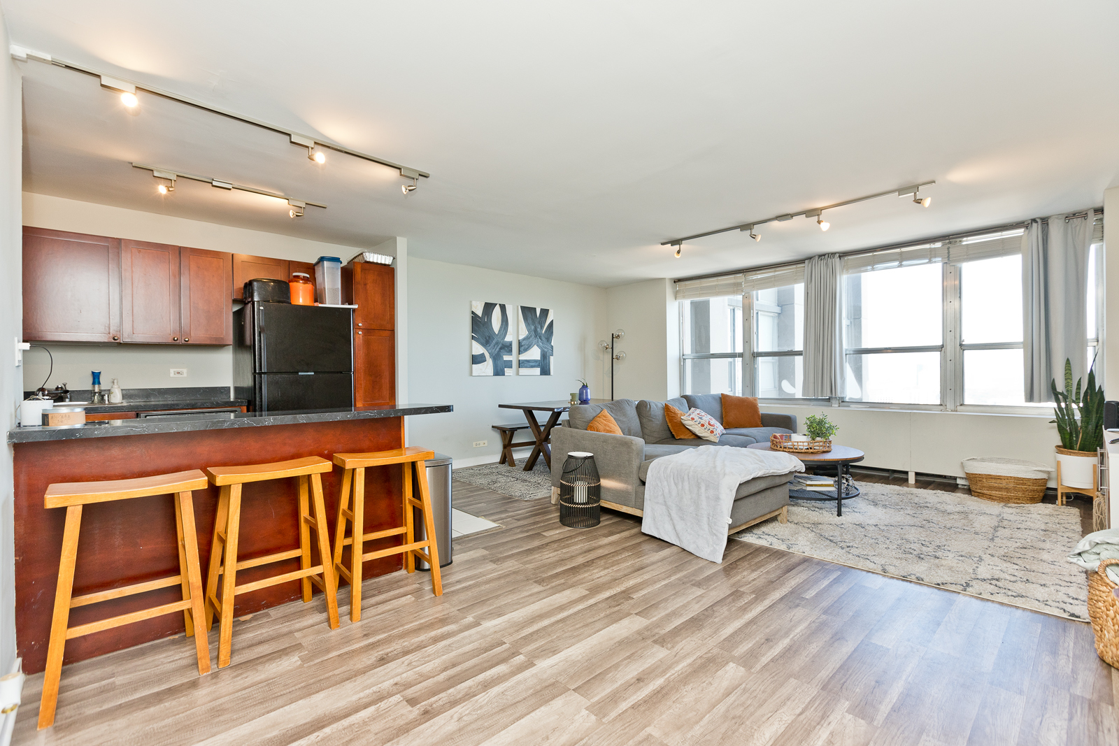 655 West Irving Park Road, Unit 4008 Chicago, IL 60613 - Photo 4 of 16 a living room with furniture a wooden floor and a window