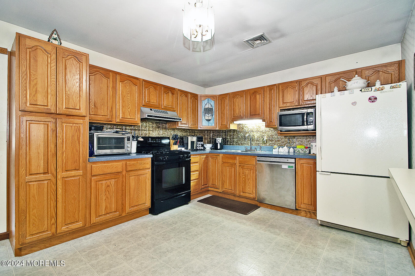 27 Barnegat Beach Drive Waretown, NJ 08758 - Photo 8 of 23 a kitchen with stainless steel appliances granite countertop a refrigerator a stove a sink dishwasher and a microwave oven