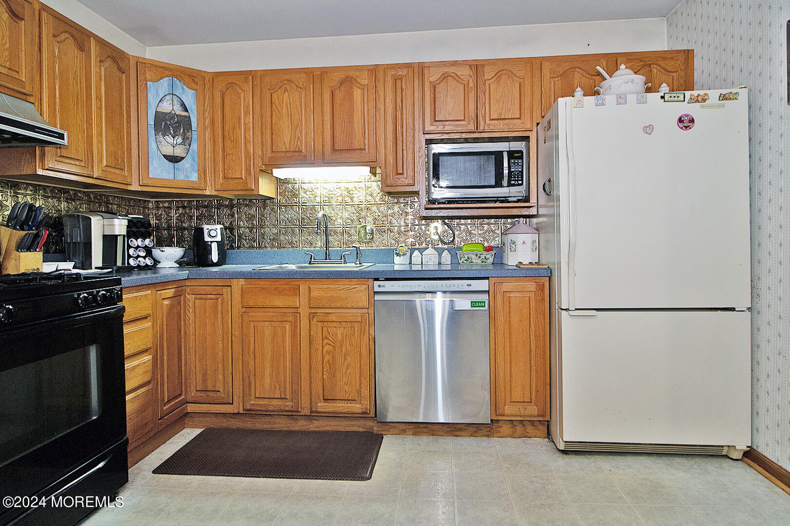 27 Barnegat Beach Drive Waretown, NJ 08758 - Photo 10 of 23 a kitchen with stainless steel appliances granite countertop a refrigerator a stove a sink and a microwave