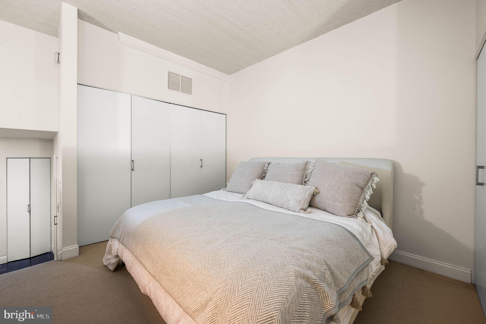 2429 Locust Street, Unit 409 Philadelphia, PA 19103 - Photo 11 of 25 a bedroom with a bed and a cabinets