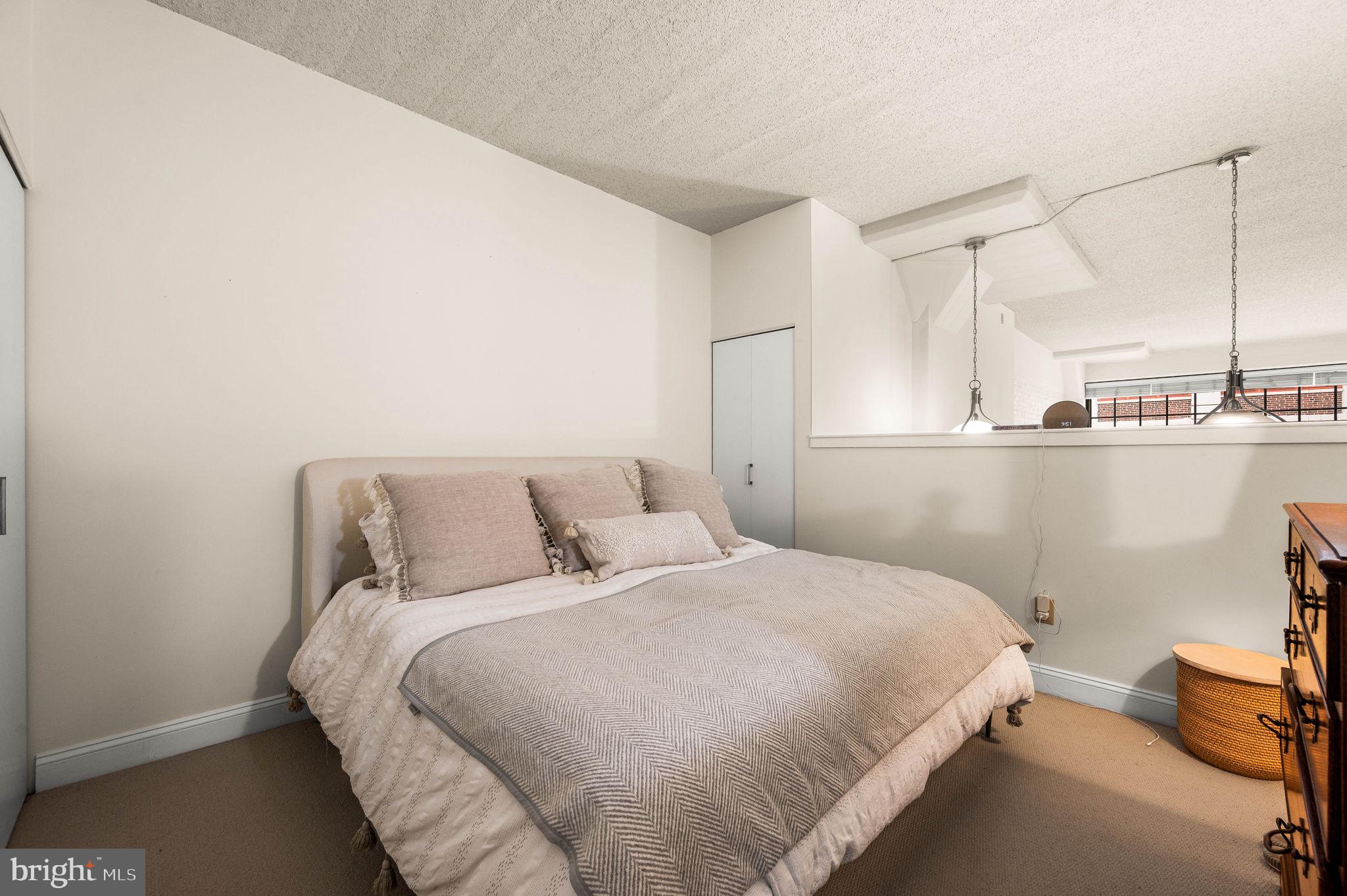 2429 Locust Street, Unit 409 Philadelphia, PA 19103 - Photo 12 of 25 a bedroom with a bed and cabinets