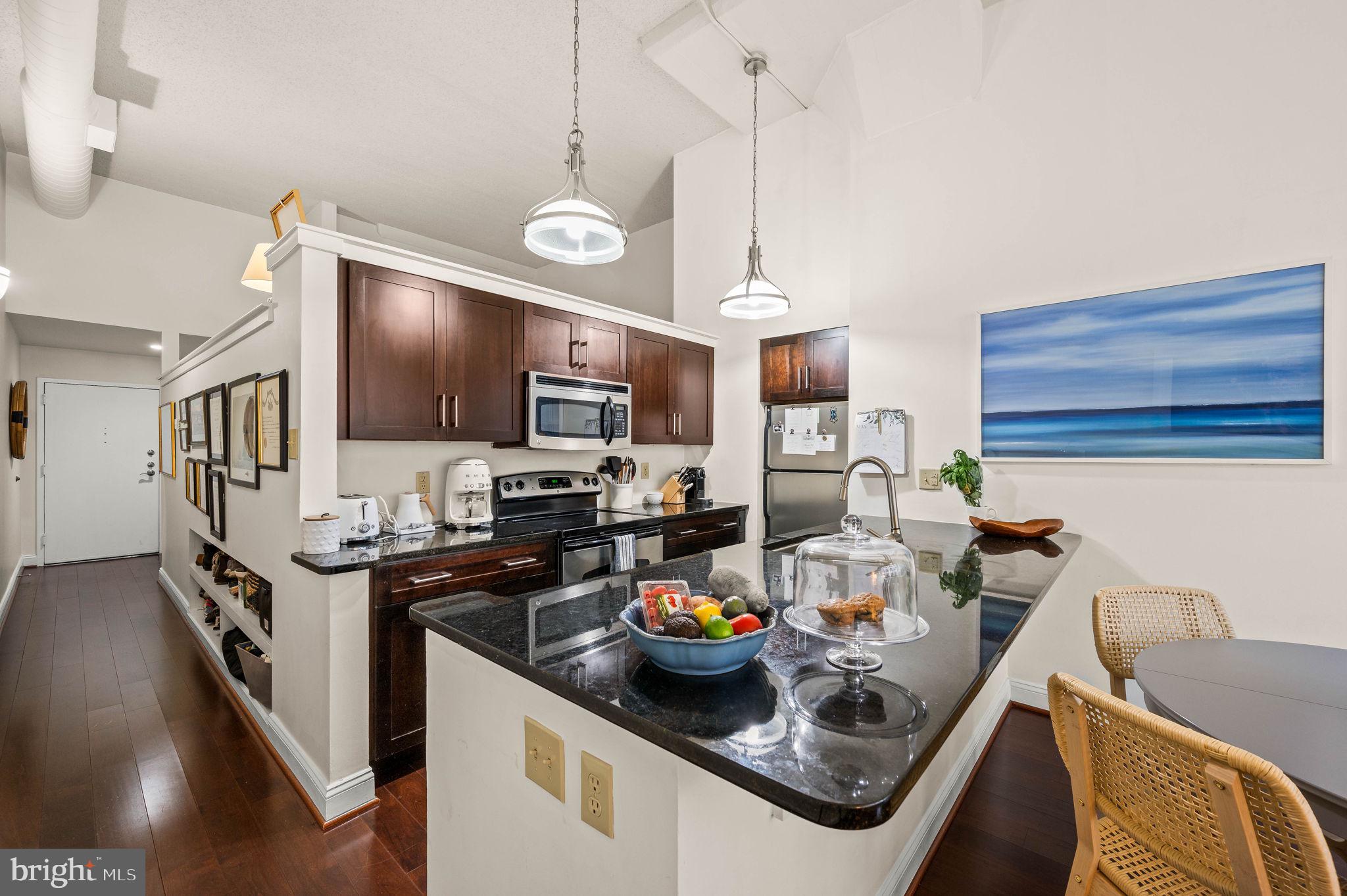 2429 Locust Street, Unit 409 Philadelphia, PA 19103 - Photo 4 of 25 a kitchen with stainless steel appliances granite countertop a sink stove and cabinets
