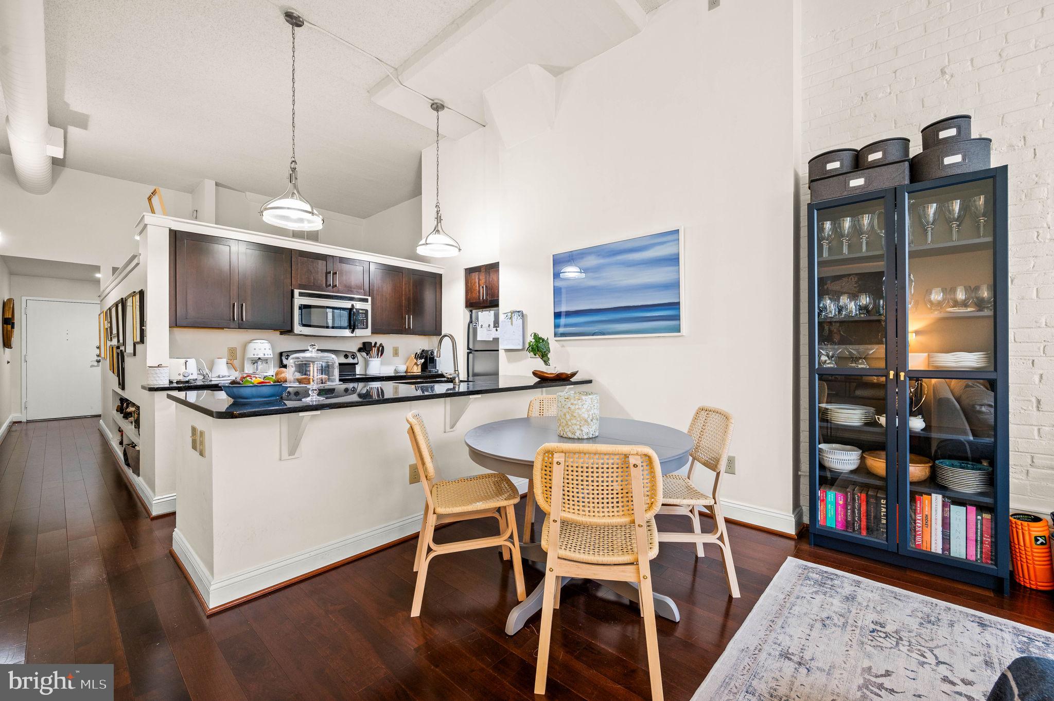 2429 Locust Street, Unit 409 Philadelphia, PA 19103 - Photo 5 of 25 a kitchen with stainless steel appliances granite countertop a stove top oven a sink a counter space and dining table