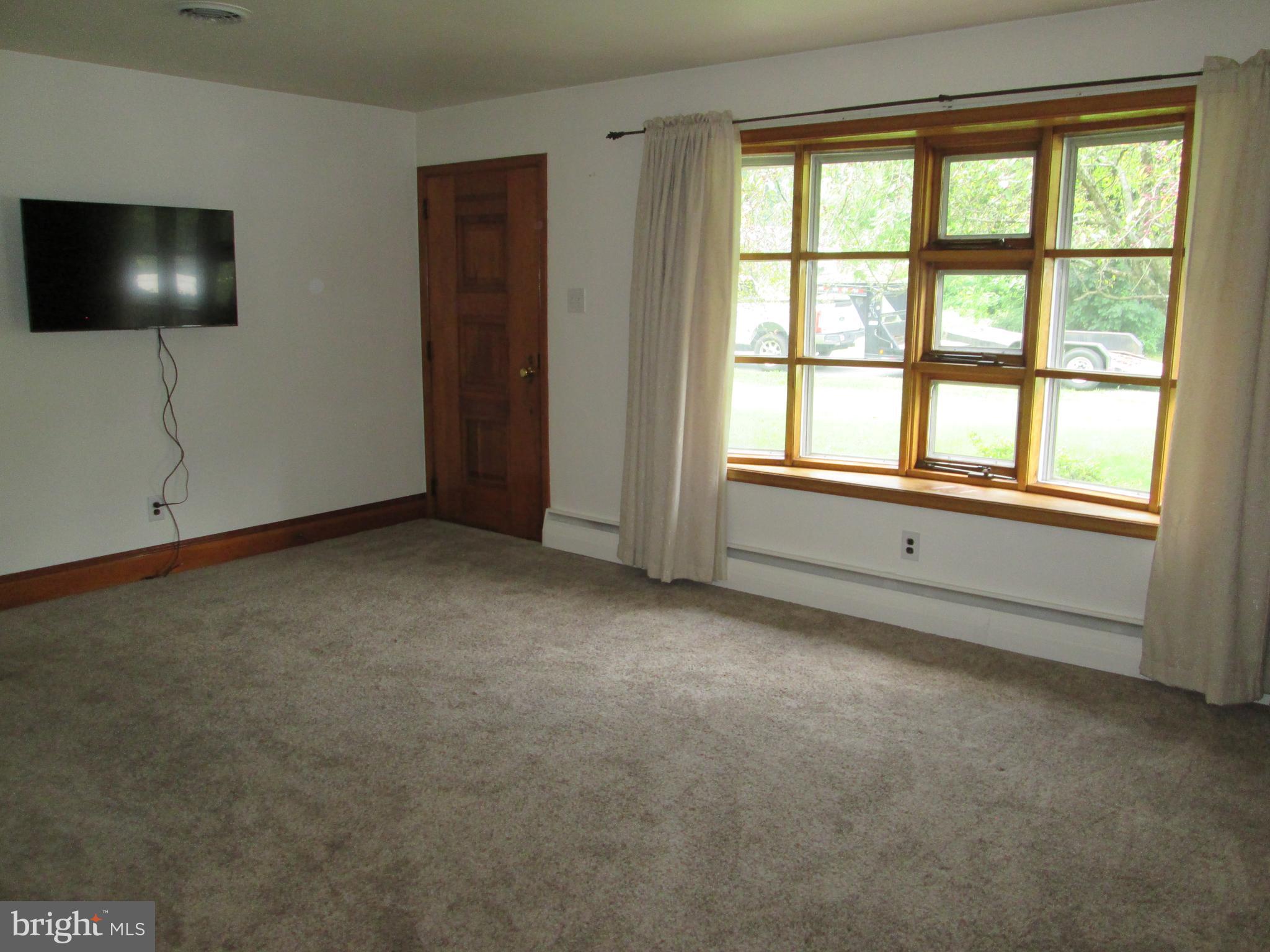 71 Woodchoppertown Road Boyertown, PA 19512 - Photo 13 of 31 a view of an empty room with a tv and a window