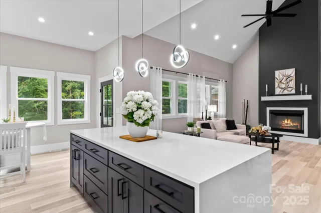 a living room with furniture a fireplace and a large window