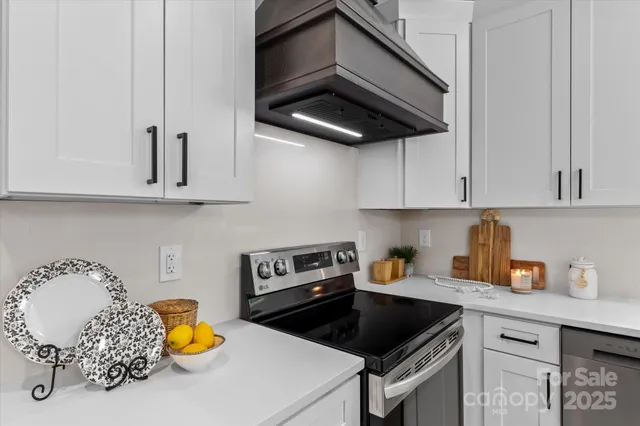 a kitchen with stainless steel appliances granite countertop a sink a stove and cabinets