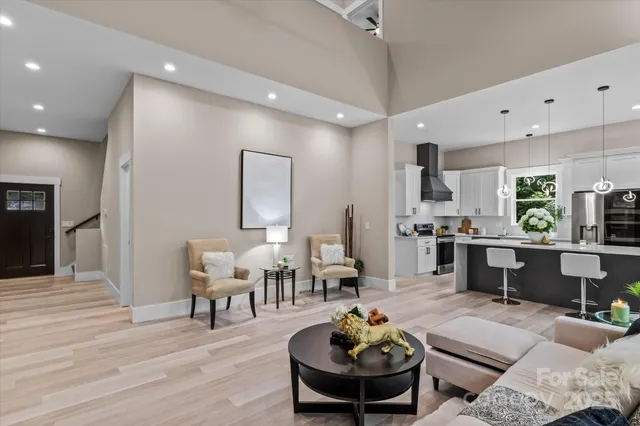 a living room with furniture kitchen and a table