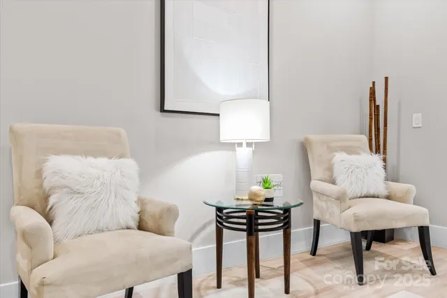 a living room with furniture and a lamp