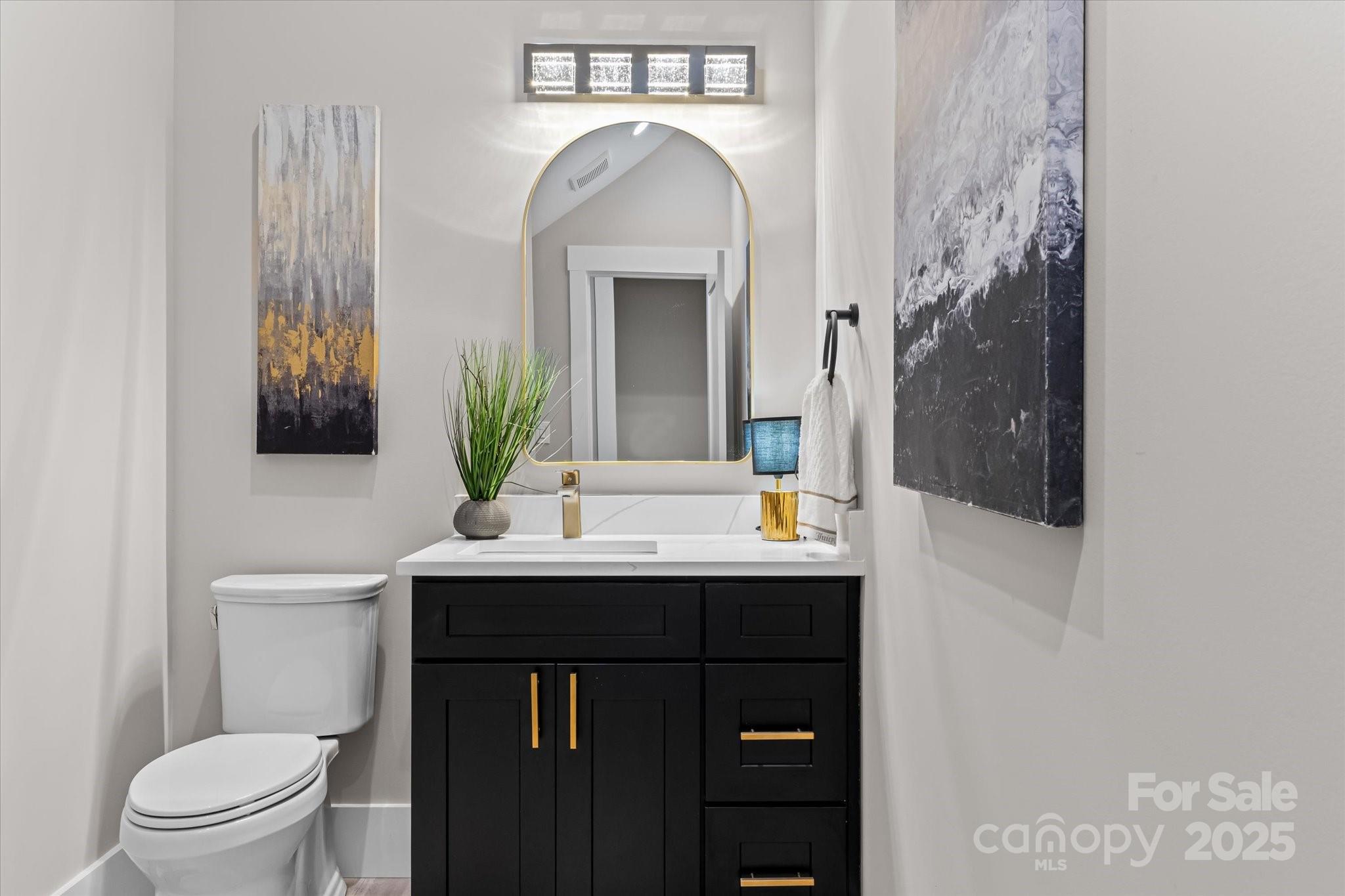 4435 Cornett Drive Iron Station, NC 28080 - Photo 18 of 46 a bathroom with a toilet sink and mirror