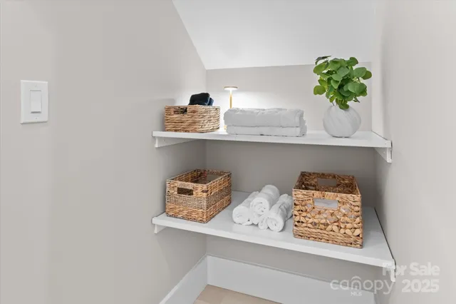 a vase of flowers sitting on a shelf