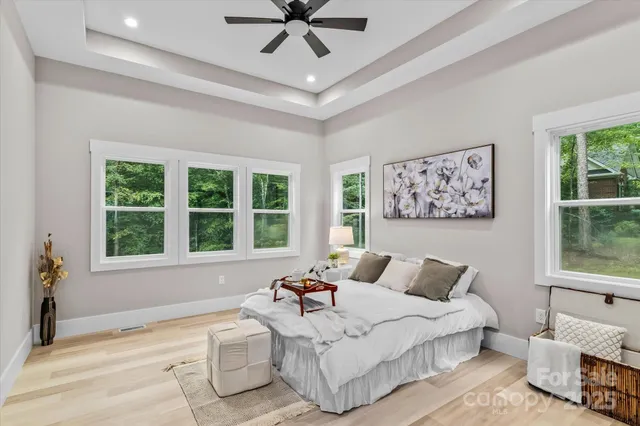 a spacious bedroom with a bed and a large window