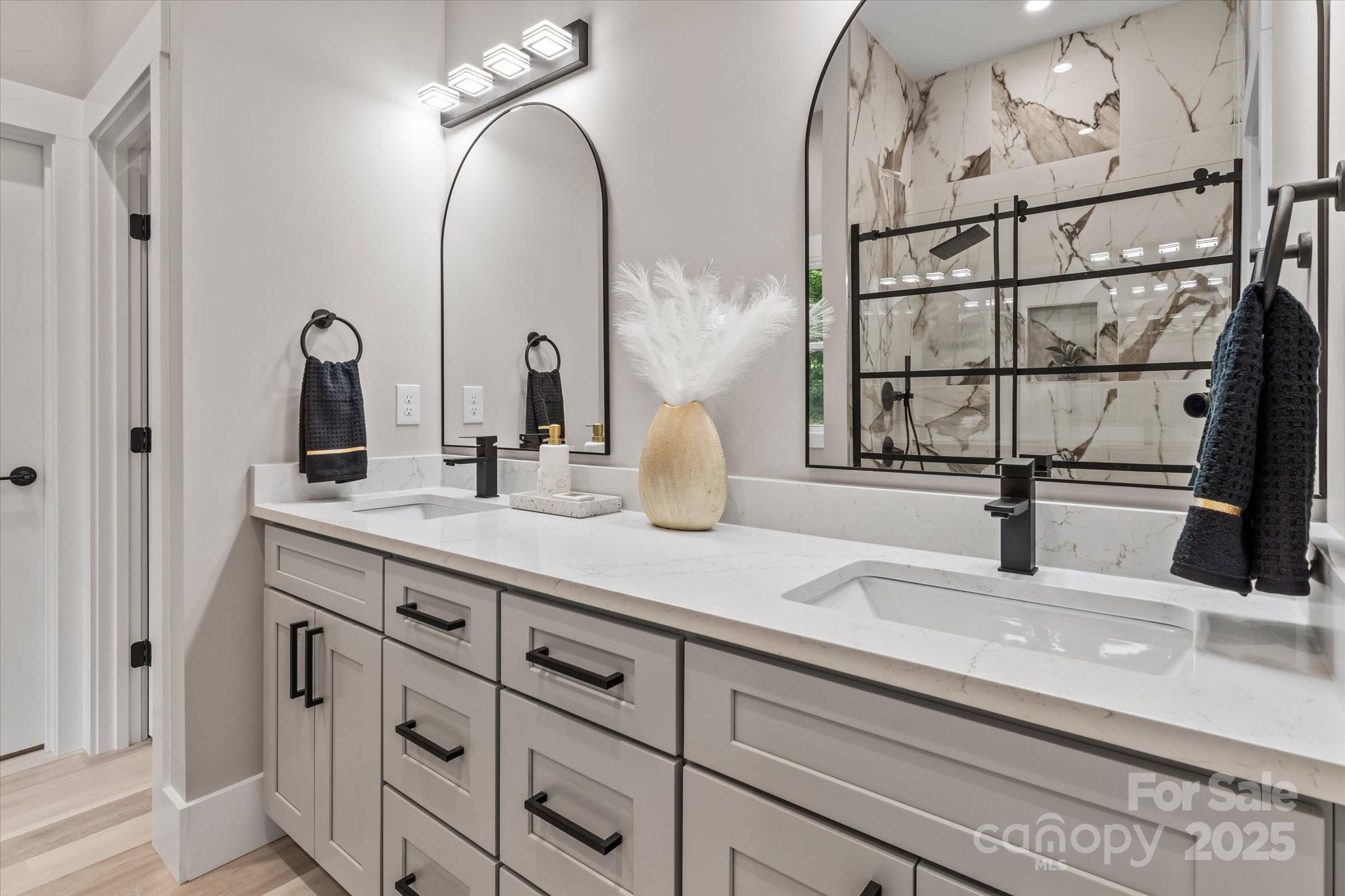 4435 Cornett Drive Iron Station, NC 28080 - Photo 25 of 46 a bathroom with a double vanity sink and a mirror