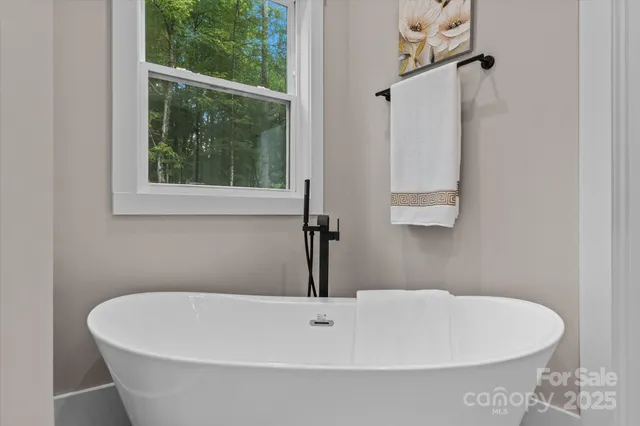 a white bath tub sitting next to a white sink