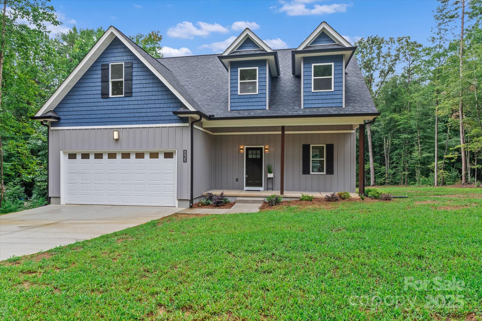 4435 Cornett Drive Iron Station, NC 28080 - Photo 3 of 46 a front view of a house with a yard and garage