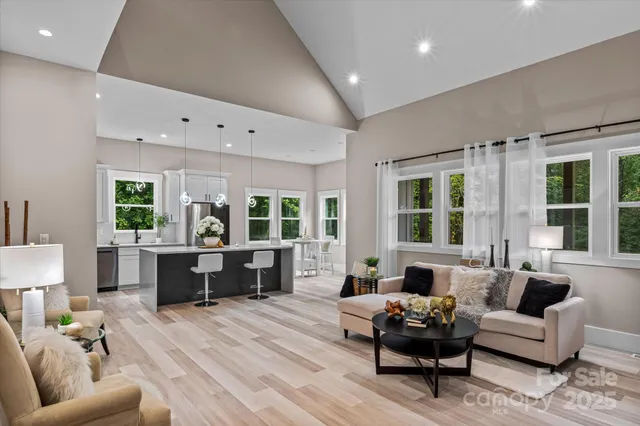 a living room with furniture and large windows